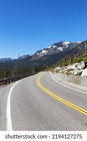 Scenic Road Surrounded By Trees And Mountains On A Sunny Day. Summer Season. Lake Tahoe, California, United States. Adventure Travel.