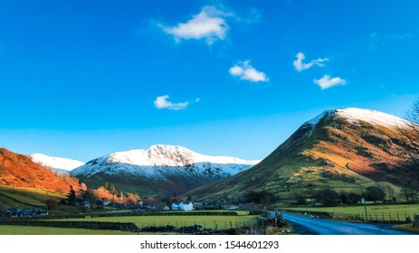 Scenic Road In The Ullswater Valley, Lake District, Cumbria, UK. Surrounded By Snow Capped Peaks On A Frosty Cold Winter Day. 