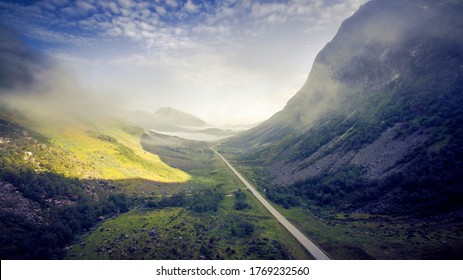 Scenic Road, View From Above. Empty Road. Rocky Road Goes Into The Distance Into The Blue Sky. Mountain Road In The Summer. Mountain Pass In Norway. Top View Through The Fog