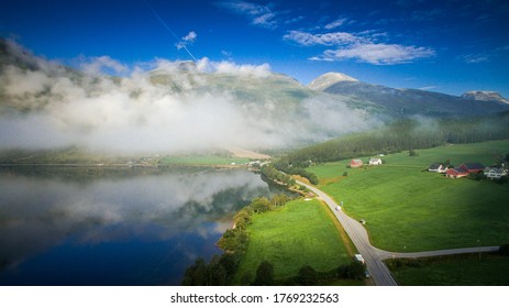 Scenic Road, View From Above. Empty Road. Rocky Road Goes Into The Distance Into The Blue Sky. Mountain Road In The Summer. Mountain Pass In Norway. Top View Through The Fog