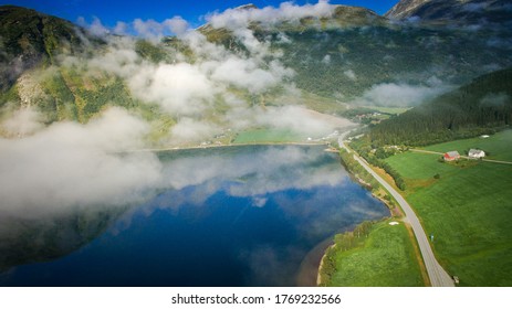 Scenic Road, View From Above. Empty Road. Rocky Road Goes Into The Distance Into The Blue Sky. Mountain Road In The Summer. Mountain Pass In Norway. Top View Through The Fog