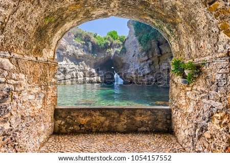 Scenic rock arch balcony overlooking an idyllic beautiful natural pool in Sorrento, Bay of Naples, Italy