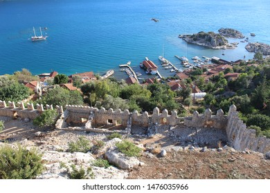 Scenic sea landscape with stone walls and towers of the Simena Byzantine castle (Simena Kalesi) in Kalekoy village, Demre, Turkey
