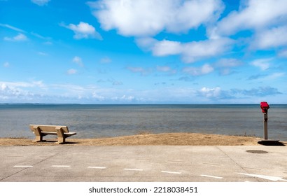 Scenic Sea View With Bench And Zoom Binoculars. Blue Ocean Water And Sky With Clouds Beautiful Seashore