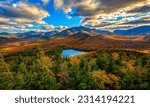 A scenic shot of the Adirondacks in the background of the fall forest
