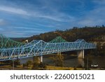 A scenic shot of the blue Owensboro Bridge against the green valley background in Indiana