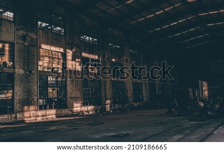 A scenic shot of a dark, abandoned building with a metallic ceiling