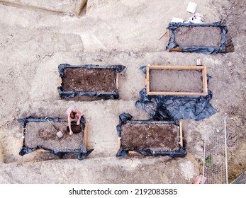 A Scenic Shot Of A Lady Preparing A Raised Vegetable Garden Bed