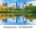 scenic skyline of Houston, Texas in morning light seen from Buffalo bayou park and reflection in river