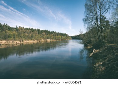 scenic spring colored river in country with trees and reflections - vintage matte look - Shutterstock ID 643504591