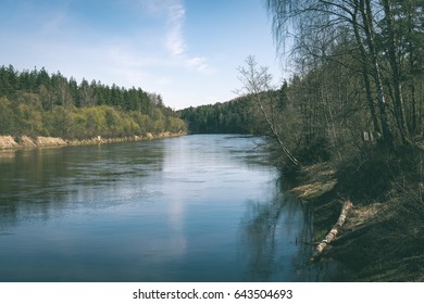 scenic spring colored river in country with trees and reflections - vintage matte look - Shutterstock ID 643504693