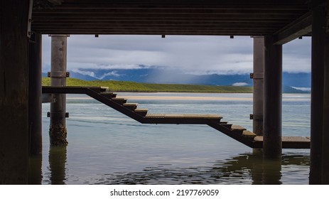 Scenic Stormy Cloudy Tropical Far North Queensland Landscape Looking From Under The Wharf In Port Douglas Towards Mangroves And Rain