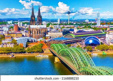 Scenic summer aerial panorama of the Old Town pier architecture with Cathedral Church and Hohenzollern railway bridge over Rhine River in Cologne or Koln, North Rhine-Westphalia, Germany