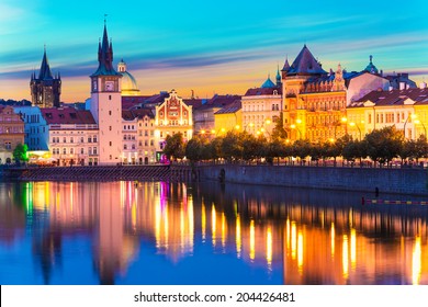 Scenic summer sunset panorama of the Old Town ancient architecture and Vltava river pier in Prague, Czech Republic
