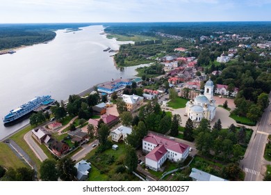 Scenic Summer View From Drone Of Ancient Town Of Myshkin Located On Steep Left Bank Of Volga Overlooking Modern River Station And Medieval Temples, Russia..