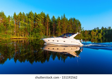 Scenic summer view of recreational yacht sailing by the lake water landscape among islands with deep forests in Finland - Powered by Shutterstock