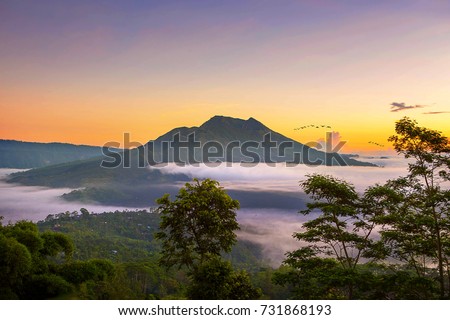 Scenic sunrise and mist at Batur volcano, Kintamani, Bali, Indonesia. Sunrise view of Batur volcano.