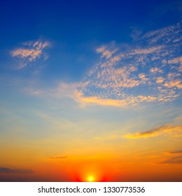 Scenic sunset on background bright blue sky and orange clouds - Shutterstock ID 1330773536