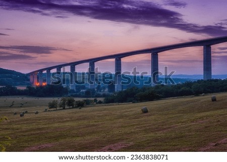 Scenic sunset view of a high road running through agricultural fields and green hills, rural landscape, outdoor travel and transportation background, Hungary