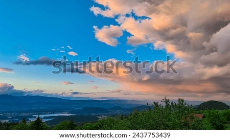 Scenic sunset view of Lake Faak seen from Altfinkenstein at Baumgartnerhoehe, Carinthia, Austria. Tranquil atmosphere on hiking trail in spring. Overlooking Villach area surrounded by Austrian Alps