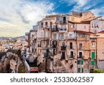 scenic travel landscape of beautiful historic town Tropea in Italy with old antique buildings, vintage houses on a high rock cliff above sea and amazing blue sky on background