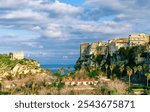 scenic travel landscape of beautiful historic town Tropea in Italy with old antique buildings, vintage houses on a high rock cliff above sea and amazing blue sky on background