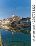 Scenic view of Aare River with the old town of Swiss City of Thun and castle and church on a hill on a sunny winter day. Photo taken February 21st, 2023, Thun, Switzerland.