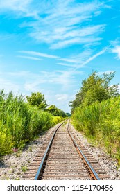 Scenic view of an abandoned railroad line, under a blue sky, background with copy space