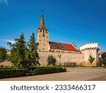 Scenic view of Aiud Citadel with tower, defensive wall and calvinist church against a cloudless sky at sunny summer day, Aiud, Alba County, Transylvania, Romania