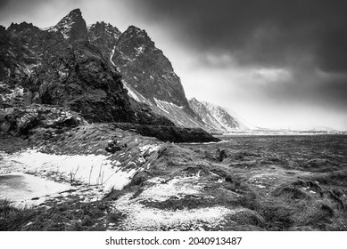 Scenic view of beautiful winter sea scandinavian landscape with blue sky, mountains and snow on the red dry grass at Lofoten Islands in Northern Norway. Black and white