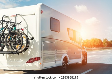 Scenic view big modern white family rv camper van vehicle driving on european highway road against blue sky in summer day. Rving motorhome lifestyle travel and adventure tourism trip journey concept - Shutterstock ID 2183988195