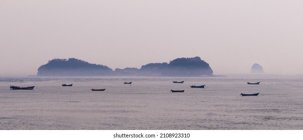 A scenic view of boats sailing in the ocean in Dalian