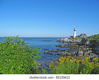 Scenic view of boulders, cliffs, water and sky at Portland Head Light at Fort Williams, in beautiful Portland, Maine.