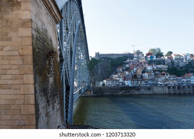 Scenic view of the bridge Dom Luis I Bridge from Vila Nova de Gaia. The river Douro, Porto, Portugal.  Shadow falling on the water. Travel photography.