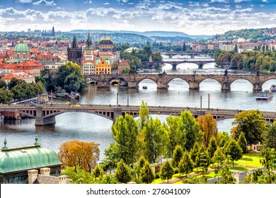 Scenic view of bridges on the Vltava river and of the historical center of Prague: buildings and landmarks of old town with red rooftops and multi-coloured walls. - Powered by Shutterstock