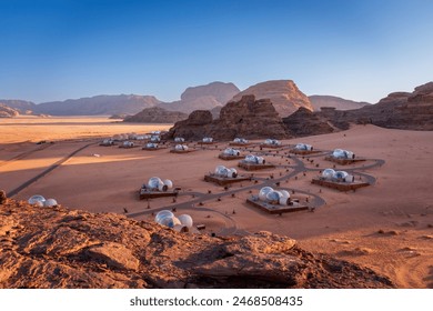 Scenic view of bubble tent camp at Wadi Rum desert in Jordan at sunrise against blue sky - Powered by Shutterstock