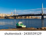 Scenic view of cable-stayed metro bridge across Golden Horn with modern cityscape of Beyoglu district of Istanbul on sunny day, Turkey..