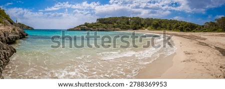 Scenic view of Cala S’Amarador, an empty sandy beach in Mondrago Natural Park, Mallorca. Crystal clear turquoise Mediterranean water, peaceful atmosphere and untouched natural coastline in the Balearic Islands, Spain.