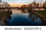 A scenic view of the calm Lake Lloydminster in Alberta, Canada during sunset