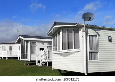Scenic view of a caravan or trailer park in summer with blue sky and cloudscape background.