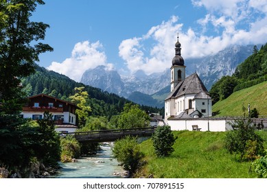 Scenic view of church of St Sebastian Ramsau in Berchtesgaden  against Alps mountains a sunny day of summer