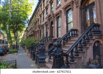 Scenic View Of A Classic Brooklyn Brownstone Block With A Long Facade And Ornate Stoop Balustrades In New York City