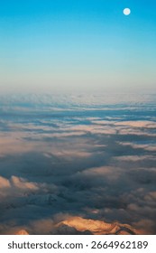 Scenic view of cloudscape over snowcapped mountains against blue sky at dusk