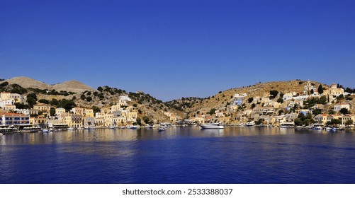 A scenic view of a coastal town with colorful buildings and boats on a clear day with a bright blue sky. - Powered by Shutterstock