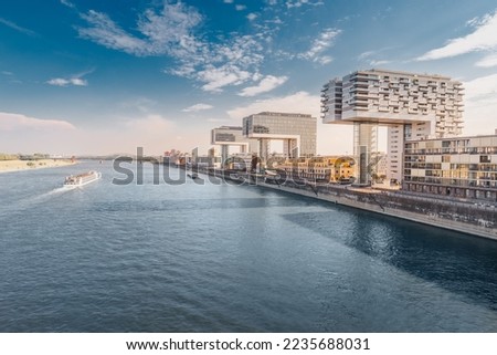 Scenic view of a Cologne cityscape skyline with Rhine river and modern residential buildings