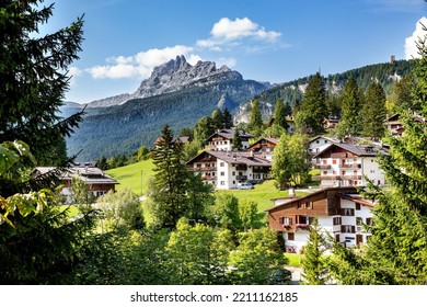 A scenic view of Cortina d'Ampezzo Dolomites town on ahill wit green trees and mountainous landscape - Shutterstock ID 2211162185