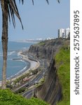 Scenic view of Costa Verde in Lima, Peru, with coastal highway, cliffs, and city skyline under a clear blue sky.