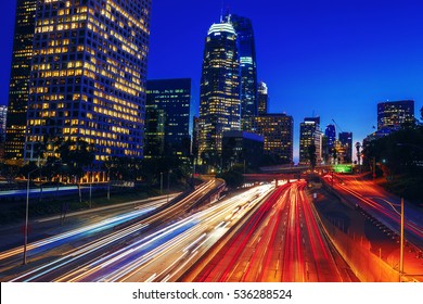 Scenic View Of Downtown Los Angeles California At Night Overlooking Busy Freeway With Light Trails