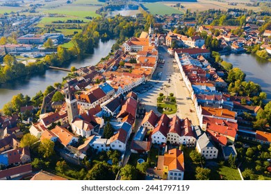 Scenic view from drone of historic part of Czech town of Telc with brownish tiled roofs of houses and medieval Castle surrounded by ponds.. - Powered by Shutterstock