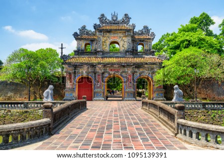 Scenic view of the East Gate (Hien Nhon Gate) to the Citadel with the Imperial City on summer sunny day in Hue, Vietnam. The colorful gate is a popular tourist attraction of Hue.